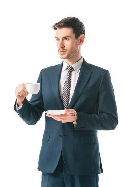 corporate businessman in suit holding coffee cup isolated on white - 写真・画像