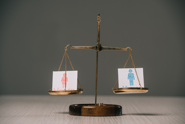 male and female symbols on scales on wooden table on grey, gender equality concept - Photo, Image
