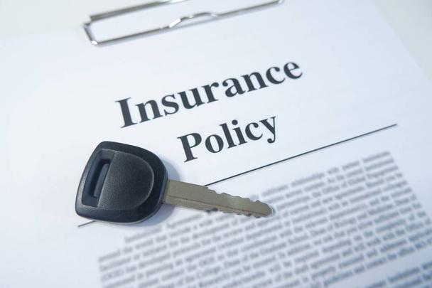 close-up insurance policy, contract with car key on table - Photo, Image
