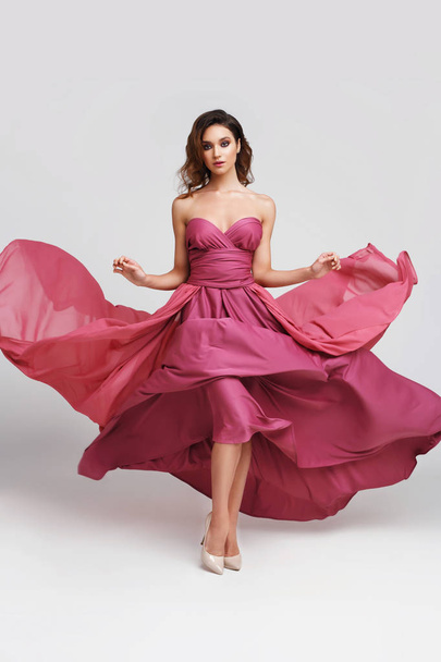 fashion shot of young woman in elegant pink dress - Photo, Image