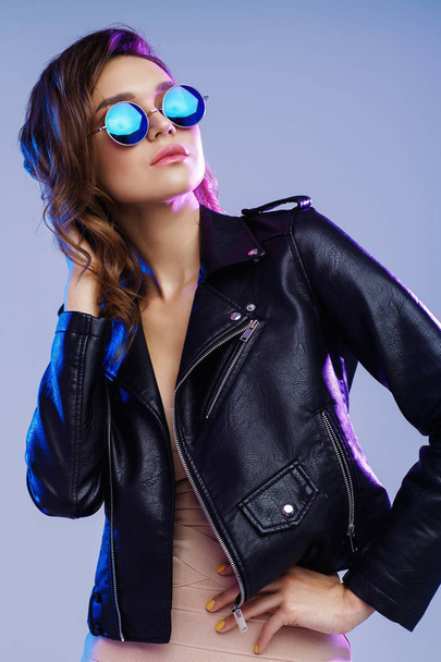 fashionable young woman in sunglasses with black leather jacket - Фото, зображення