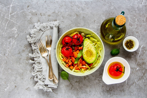 Healthy vegetarian dinner. Flat-lay of bowl with fresh salad, avocado half, grains, beans, roasted vegetables, top view. Superfood, clean eating, dieting food concept - Image - Fotografie, Obrázek