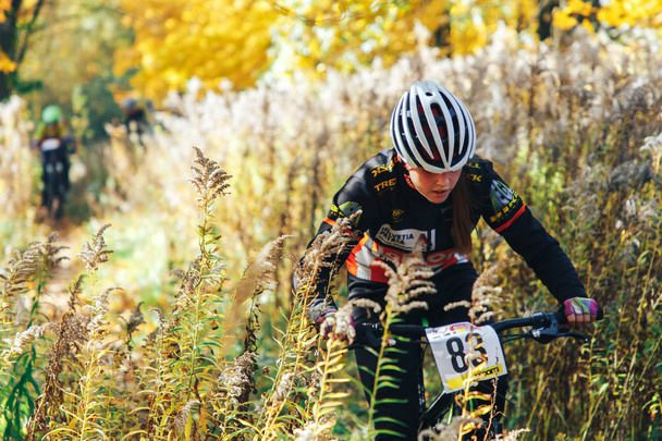 October 14, 2018 - Minsk, Belarus: 2018 Olympic Cross Country Cup XCO in Medvezhino, teenager boy riding bicycle on forest trail during race - Фото, изображение