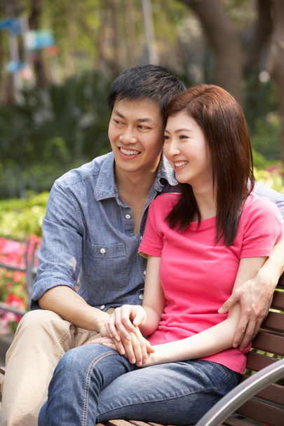 Young Chinese Couple Relaxing On Park Bench Together - Zdjęcie, obraz