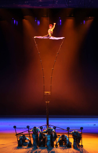 Acrobats perform during the 13th China Wuqiao International Circus Festival in Shijiazhuang city, north Chinas Hebei province, 23 October 2011 - Photo, Image
