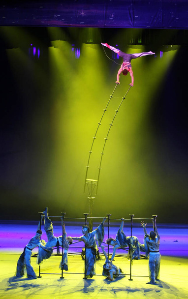 Acrobats perform during the 13th China Wuqiao International Circus Festival in Shijiazhuang city, north Chinas Hebei province, 23 October 2011 - Photo, Image