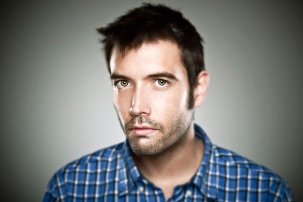 Portrait of a normal boy over grey background. - Foto, imagen