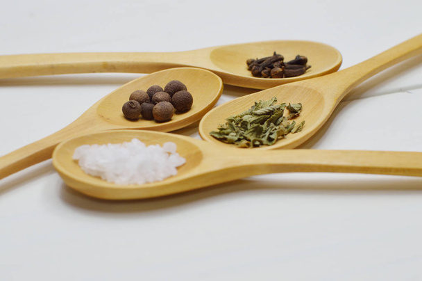 Wooden spoons with ingredients for your kitchen projects or recipe topics in your publications. - Foto, Imagen