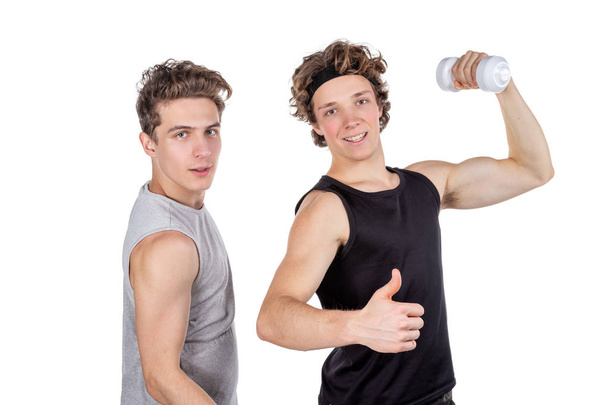 Two handsome guys doing fitness workout with weights isolated - Foto, Bild