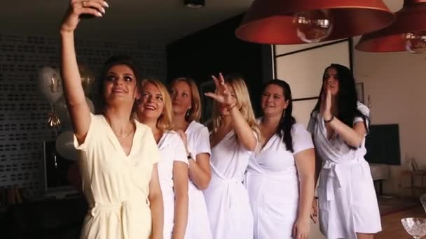Bride with her positivity girlfriends taking selfie on smartphone in bathrobes. - Footage, Video