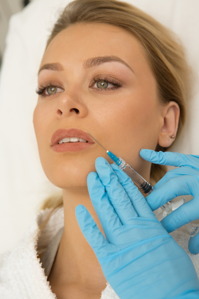 Vertical close up of beautiful young woman receiving beauty injection in her face botox fillers skincare cosmetology plastic surgery luxury wellness people beauty doctor medicine medical salon clinic - Photo, Image
