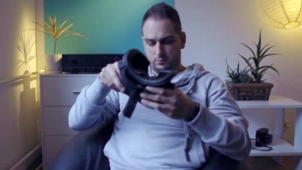 men in lazy bag putting on and enjoying vr at home virtual reality googles  - Video, Çekim