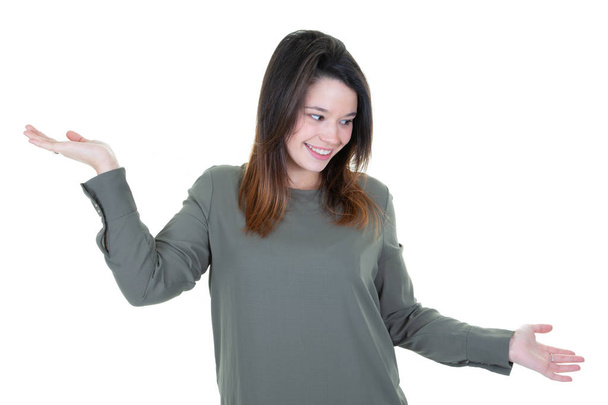 cute woman in doubt doing shrug showing open palms - Photo, Image