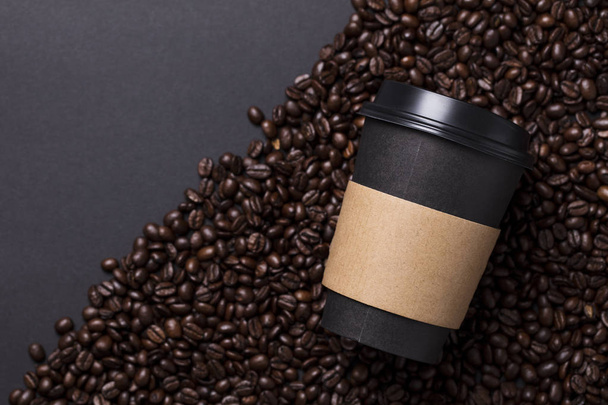 Take away black coffee cup with roasted coffee beans - Fotó, kép