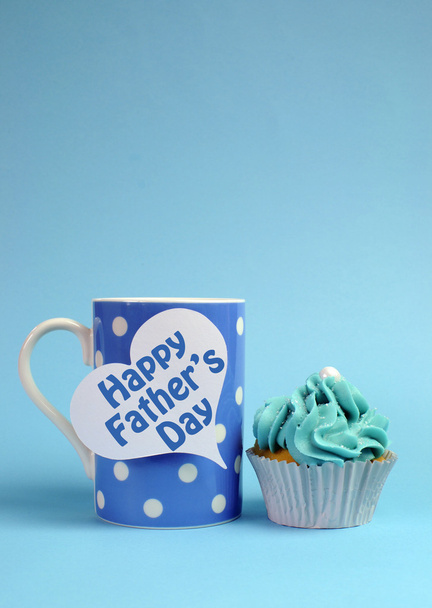 Happy Fathers Day special treat blue and white beautiful decorated cupcakes with message on blue background, with blue polka dot coffee mug. - Photo, Image