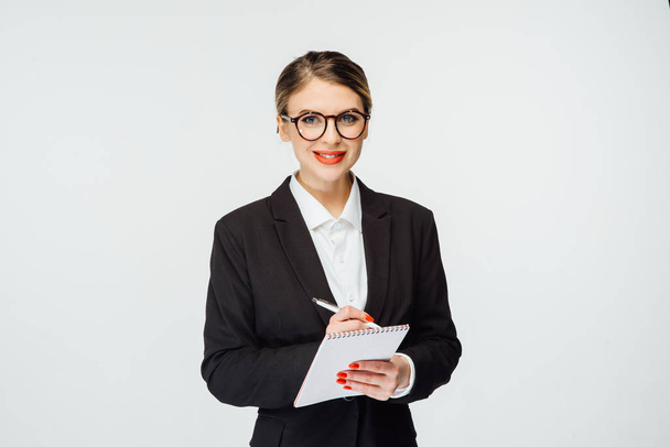 beautiful business woman standing with tablet on white background - Foto, afbeelding