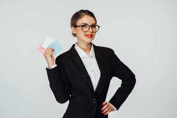 sexy business woman in glasses and in modern suit is standing on a white background - Foto, Imagem
