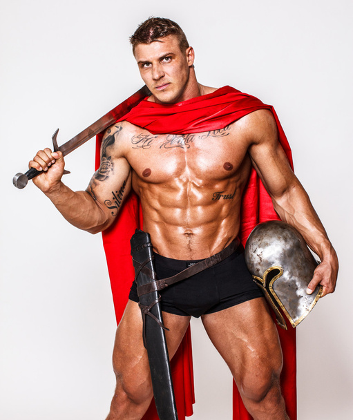Huge warrior with sword, helmet and mantle - Photo, Image