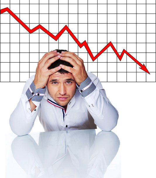 Sad businessman in front of graphic - Photo, Image