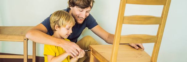 Father and son assembling furniture. Boy helping his dad at home. Happy Family concept BANNER, LONG FORMAT - Photo, image