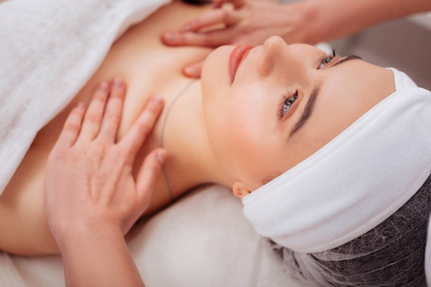 Face of an attractive young woman during spa procedure - Foto, Imagem