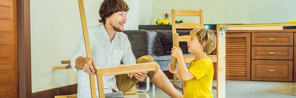 Father and son assembling furniture. Boy helping his dad at home. Happy Family concept BANNER, LONG FORMAT - 写真・画像