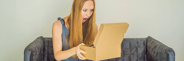 young woman received online shopping parcel opening boxes and buying fashion items by using credit card BANNER, LONG FORMAT - Zdjęcie, obraz
