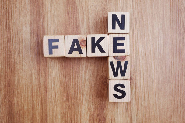 Fake News word alphabet letters on wooden background - Photo, Image