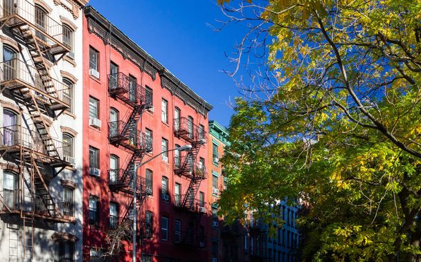 Tree lined street with old historic apartment buildings in the East Village neighborhood of New York City NYC - Photo, Image