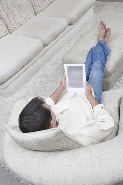 Relaxed Man Holding Digital Tablet - 写真・画像