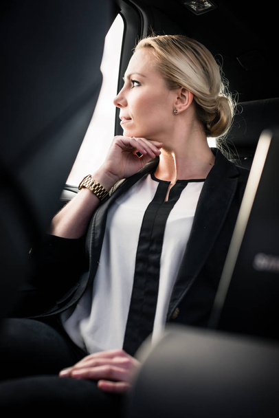 Stylish young businesswoman sitting in car - Foto, Imagem