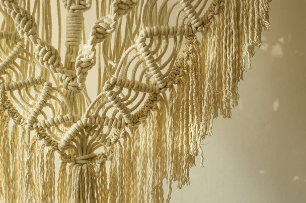Macrame panel decor made of cotton cord. Wicker hand made modern Scandinavian interior decoration - Photo, Image