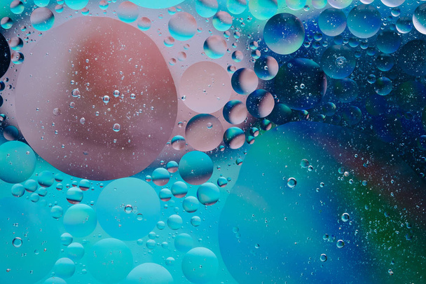 Water oil bubble macro abstract background flow liquid blue pink green colors - Photo, Image