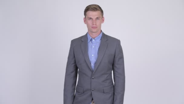 Young handsome businessman wearing suit - Felvétel, videó