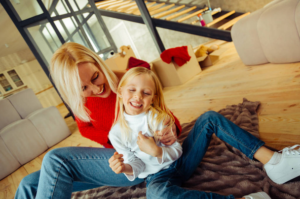 Kind blonde female playing with her daughter - Photo, Image
