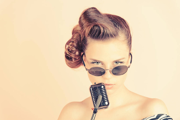 Girl in glasses sing in microphone. - Φωτογραφία, εικόνα