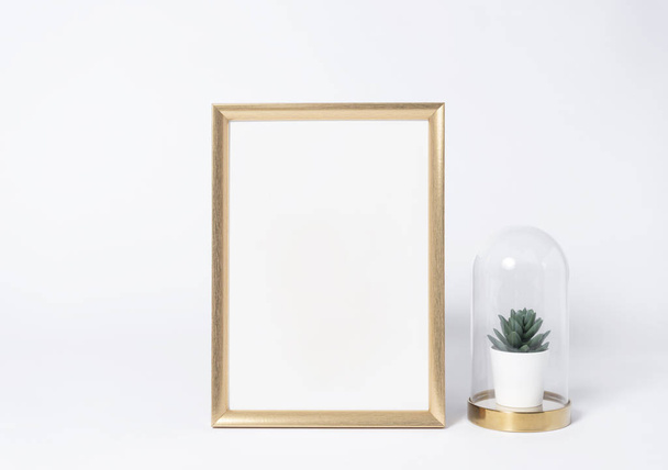 golden photo frame mock up and plants in vase Interior decor home elements. - Photo, Image