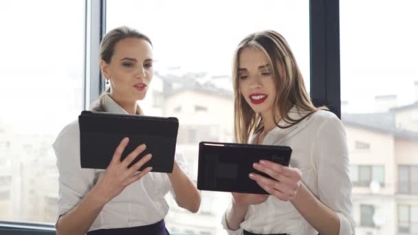 4. Young and adult pretty business woman  in office working by tablet and discuss.  - Felvétel, videó