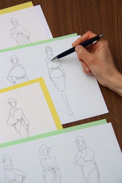 designer assessing fashion drawings - Foto, immagini