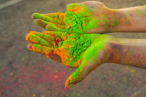 Two hands with green and orange dry hawley paint - Zdjęcie, obraz