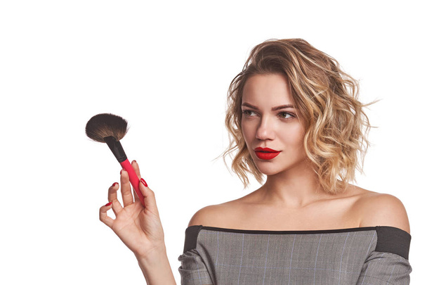Fashionable woman stylist standing posing with makeup brush - Фото, изображение