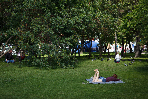 Russia. Siberia. People relax on the lawn in the Park - Photo, image