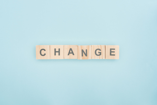 top view of change lettering made of wooden blocks on blue background - Foto, imagen