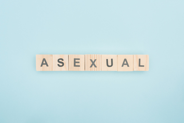 top view of asexual lettering made of wooden cubes on blue background - Photo, Image