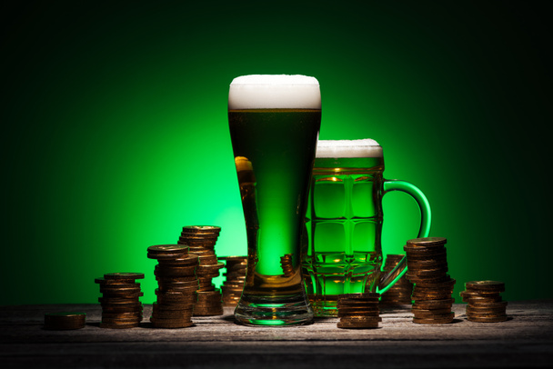 Gläser irisches Bier stehen auf einem Holztisch auf grünem Hintergrund - Foto, Bild
