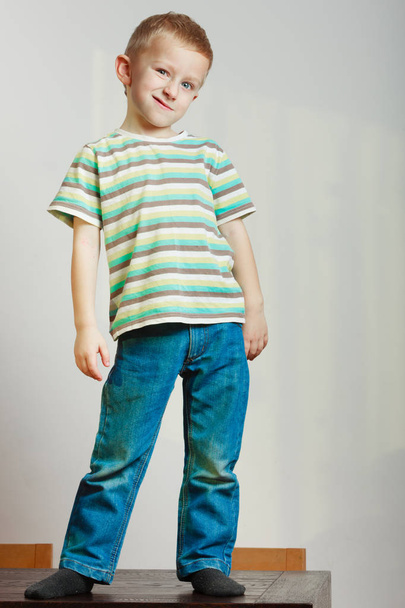 Face expressions, children fashion concept. Portrait of happy kid boy looking straight to camera - Photo, image