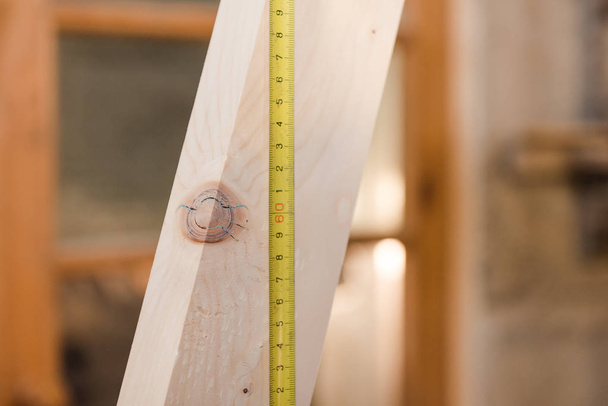 Measure roll line in the woodwork. Draw on wood. Measure the distance during construction. Carpentry workshop. Carpenter makes the detail. - Φωτογραφία, εικόνα