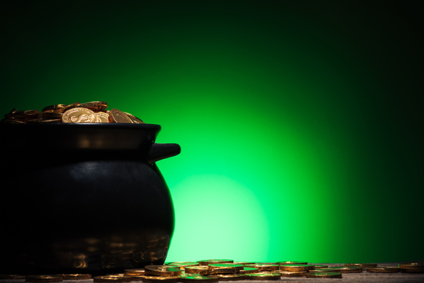 pot with golden coins on st patricks day on green background - Фото, зображення