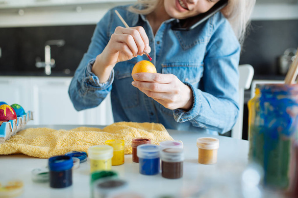 Girl paints eggs for easter - Fotó, kép