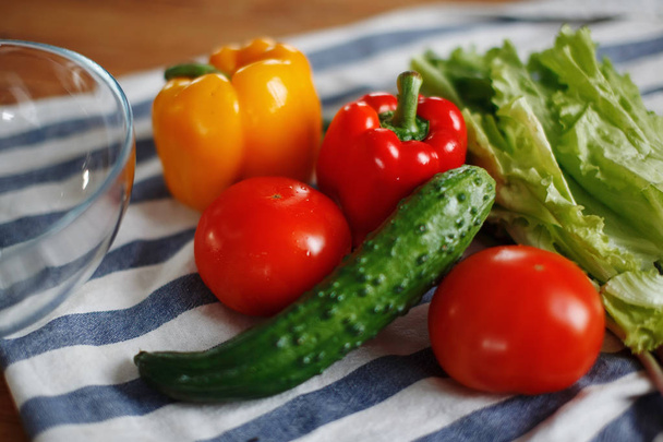 tomatoes, green cucumbers, red pepper on table, selective focus - Фото, зображення
